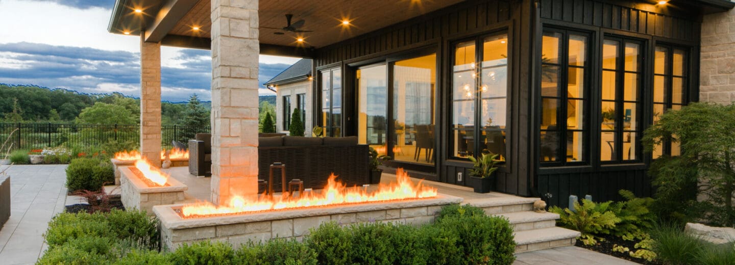 An inviting rear view of a backyard, blending stunning hardscaping with lush landscaping for a perfect outdoor space.