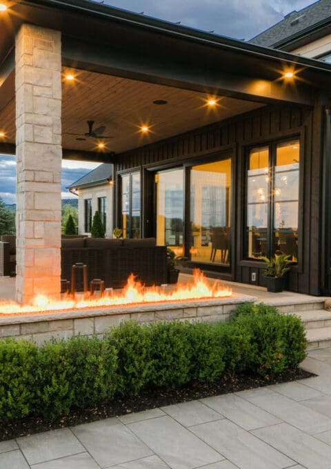 An inviting rear view of a backyard, blending stunning hardscaping with lush landscaping for a perfect outdoor space.