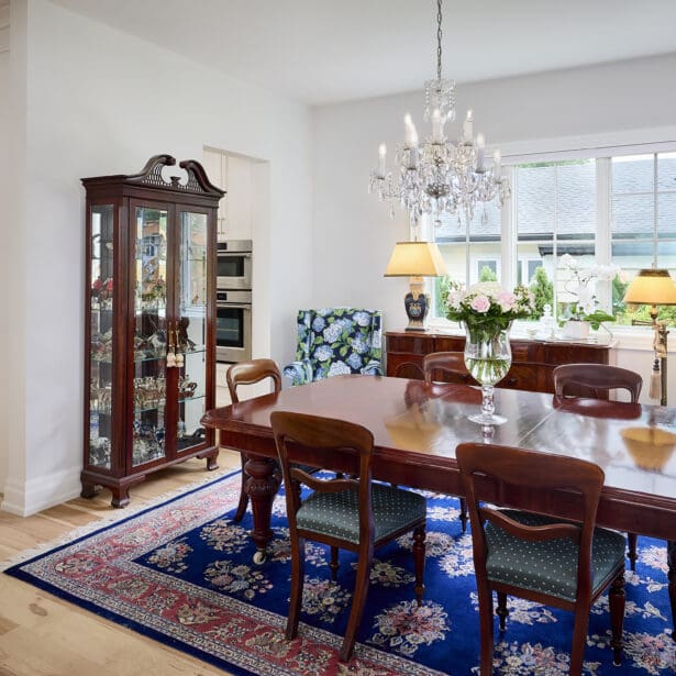 Interior view of a Victorian-inspired dining room featuring an elegant crystal chandelier, intricate moldings, and rich furnishings, creating a luxurious and timeless atmosphere.